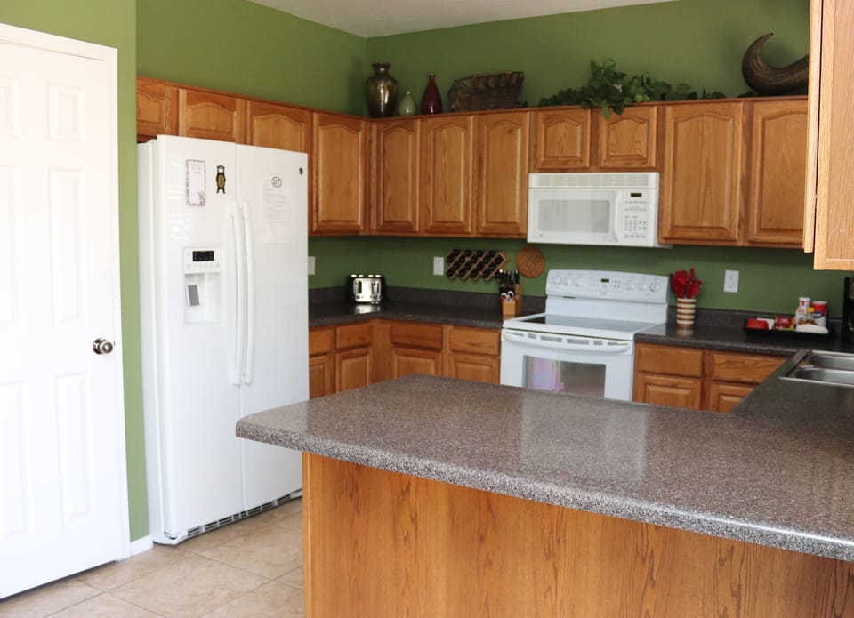 The kitchen is fully stocked with dishes, pans, and utensils.