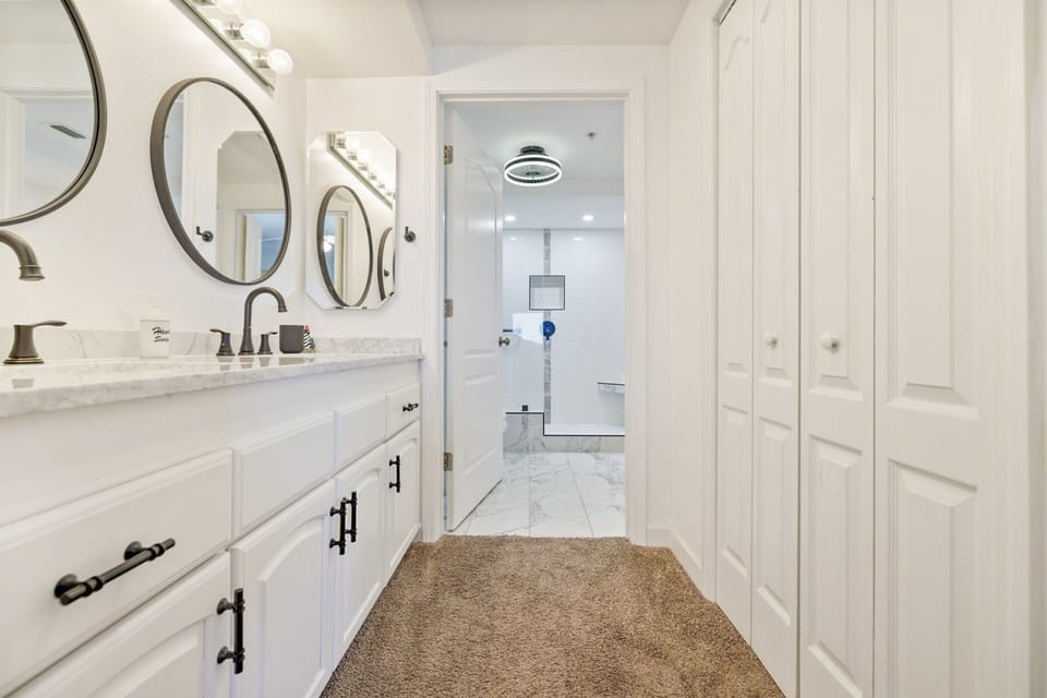 Master ensuite bathroom with 2 vanities separate from shower, tub, toilet area.
