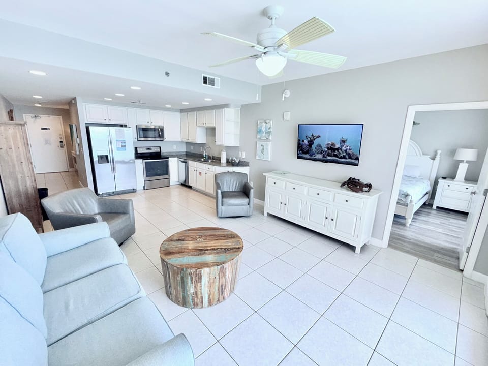 Living area w sleeper sofa, two swivel rocker chairs, mounted Roku HDTV