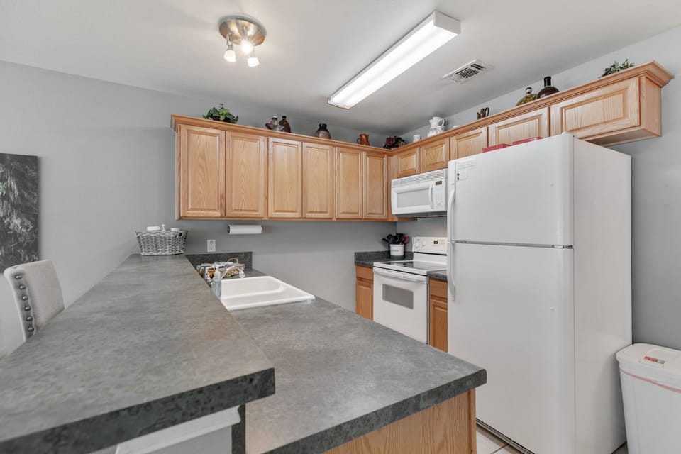includes refrigerator with ice maker, oven/range, microwave, sink disposal
