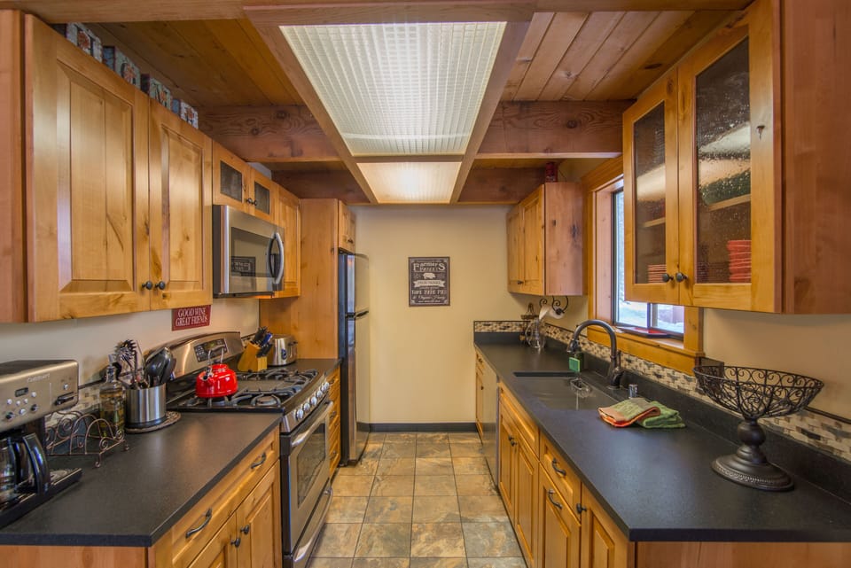 Kithen with knotty alder wood cabinet, granite counters and new appliances.