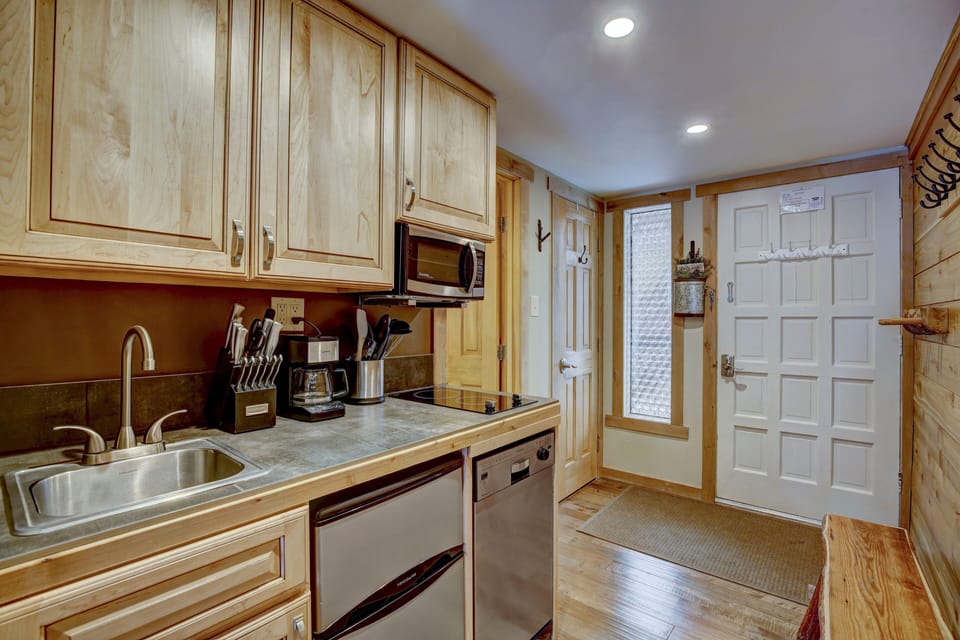 Kitchenette with two burner stovetop, microwave, dishwasher, and mini fridge
