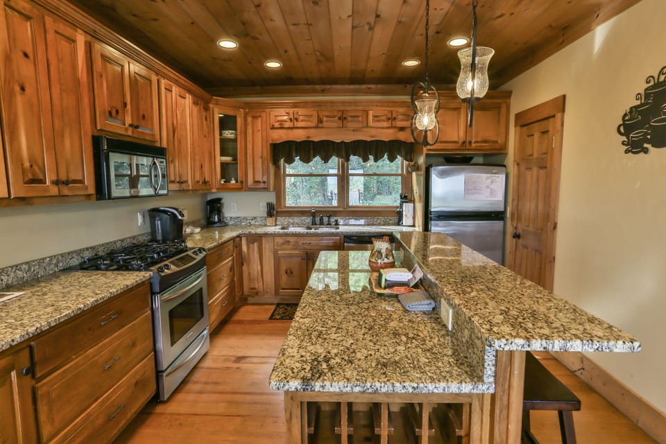 Granite counter tops and stainless steel appliances appoint this gourmet kitchen