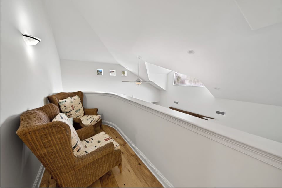 Relax in your private curved seating nook with wicker chairs and soft cushions, perfect for reading or quiet conversation.