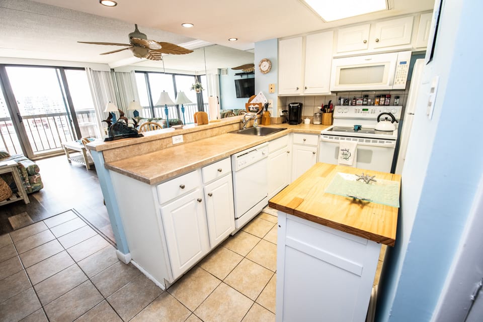 Kitchen area, Kuerig coffee maker, microwave, dishwasher & stove.