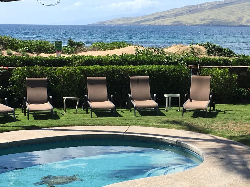 Our heated pool with the beach just 50 feet past our lava rock wall. 