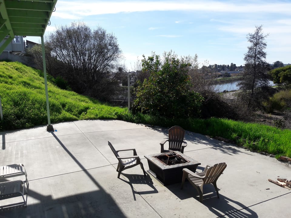 Cement Patio below deck. Sit by the firepit at night and enjoy the city lights.