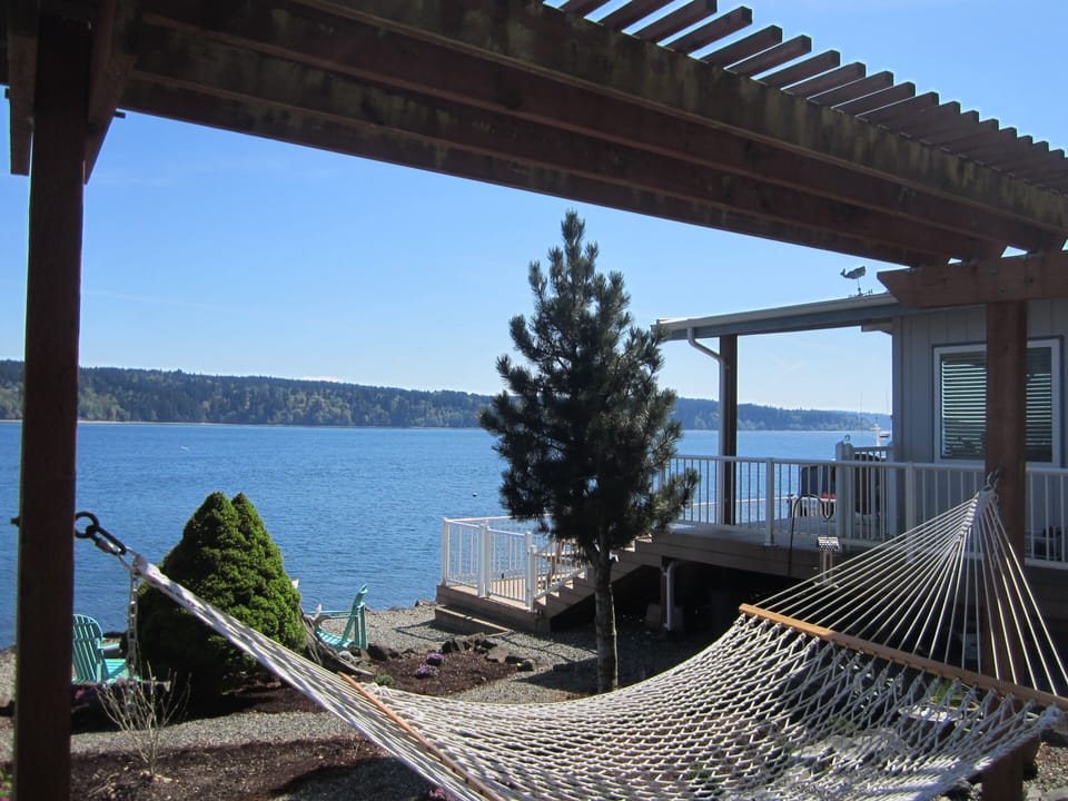 Relax on the hammock as sail boats pass by.