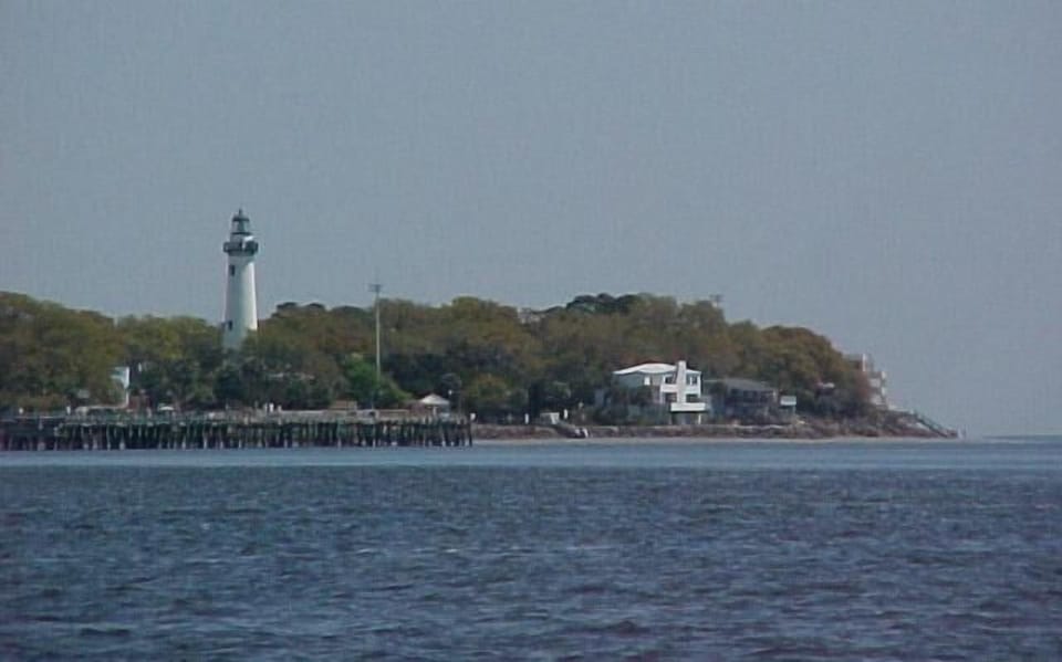 View of lighthouse and pier from the ocean