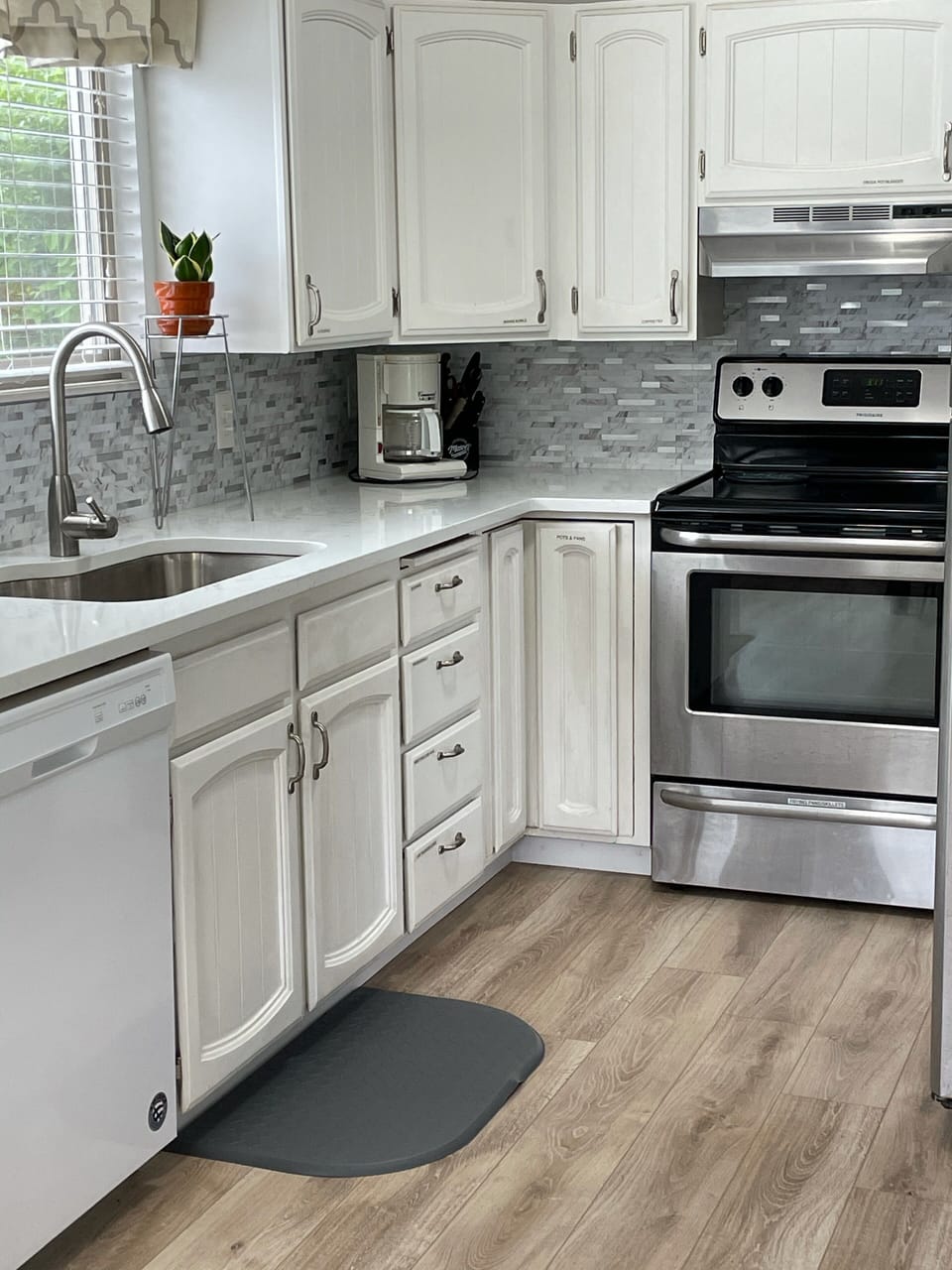 Kitchen has quartz counters, stainless appliances, and is well stocked