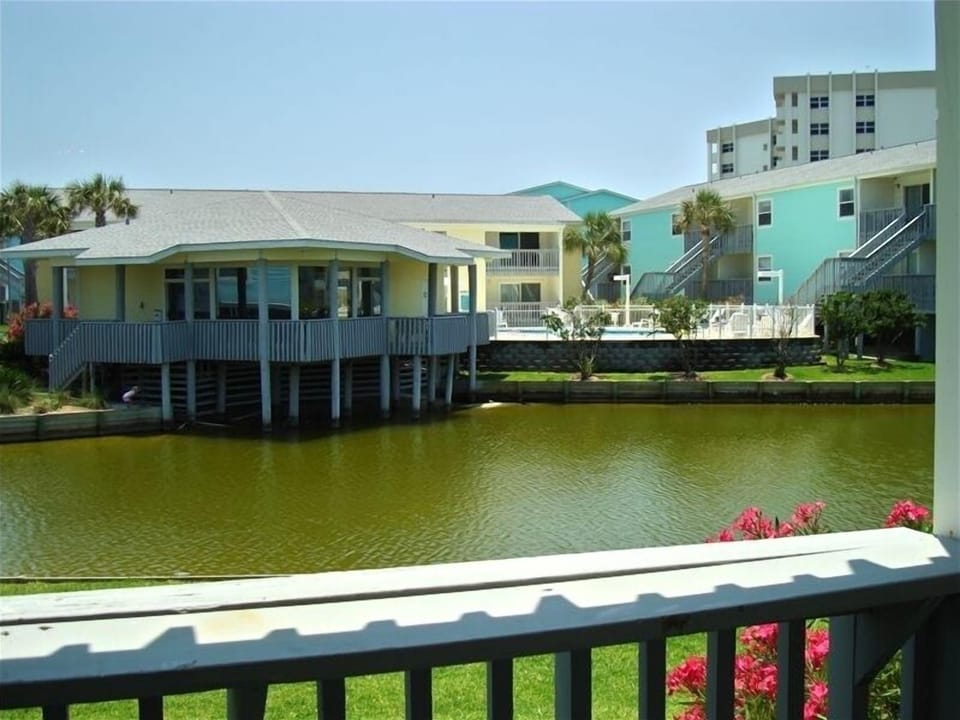 View of clubhouse, pool, and duck pond from balcony