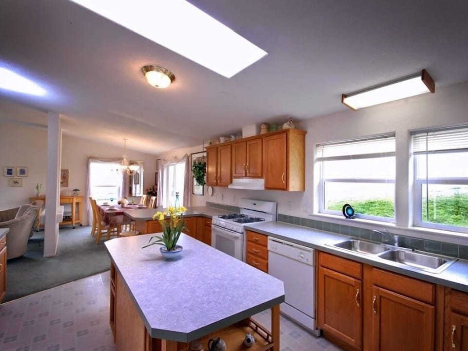 Fully stocked kitchen with side-by-side fridge, island & breakfast bar