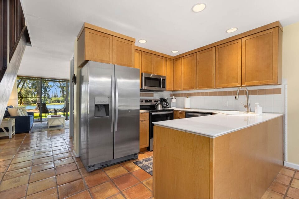 Sleek kitchen w/ stainless appliances & plenty of prep space.