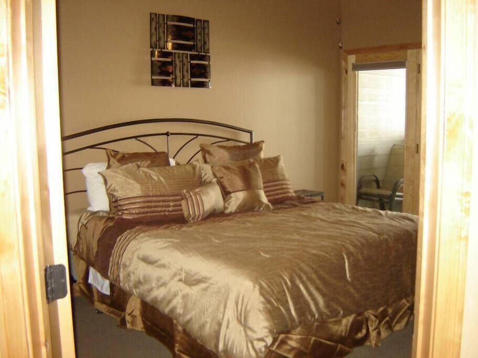 Master bedroom with private bath and door out to deck.