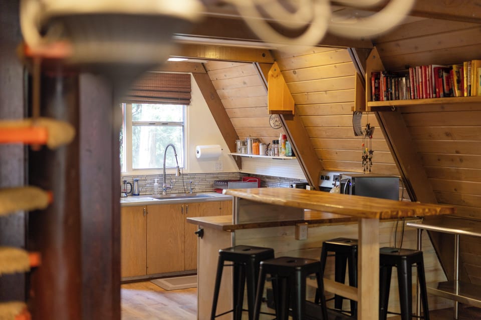 Raised Bar Seating – A Social Spot for Breakfast or Happy Hour. Kitchen Amenities include Oven, Electric Burners, Microwave and Fridge. 