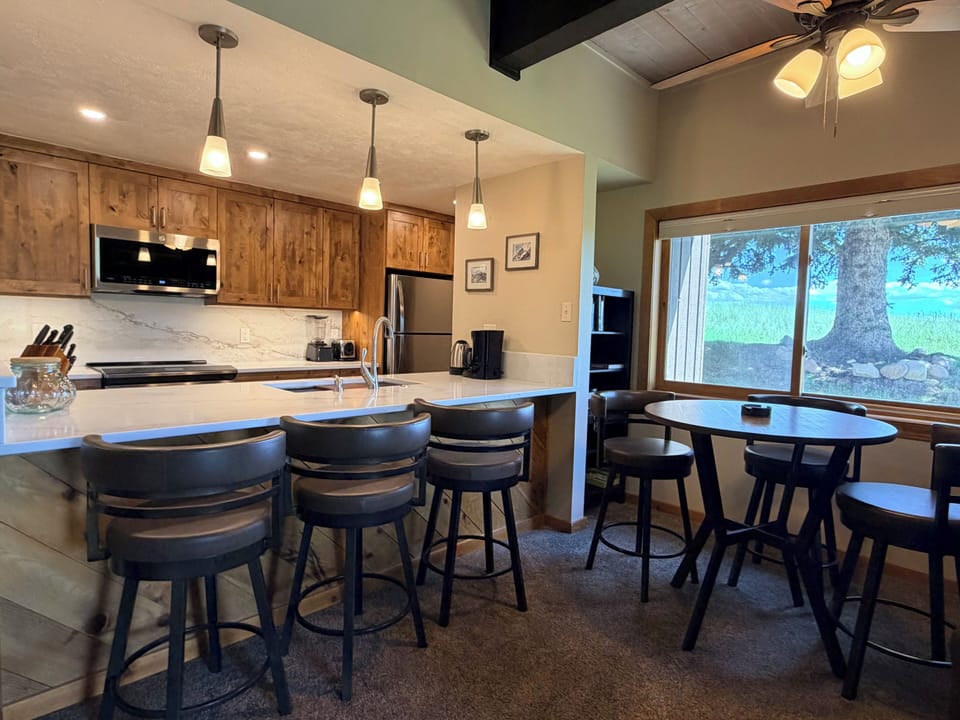 Take in the Yampa Valley View from the Kitchen and Countertop Height Dining Room