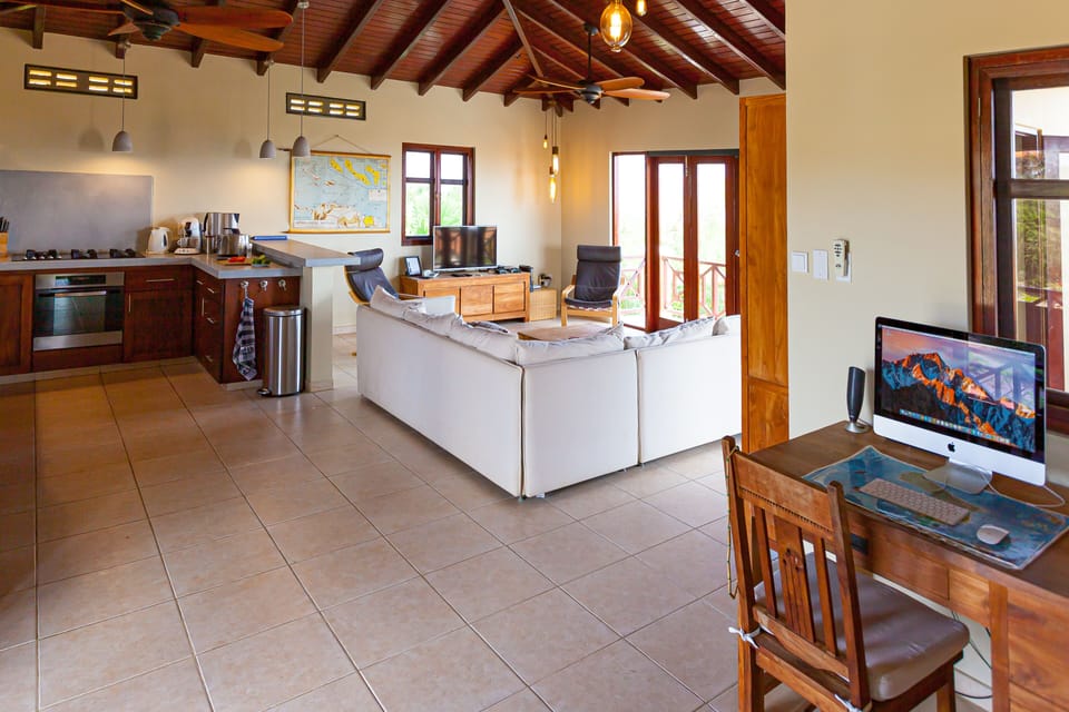 Living room, computer desk and kitchen