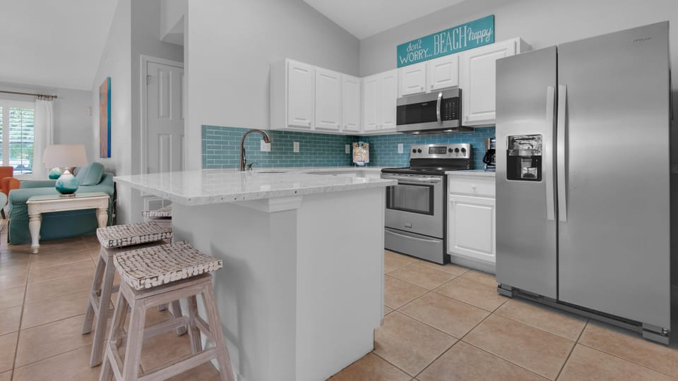 Updated kitchen with new quartz counters, tile backsplash and stainless appliances.