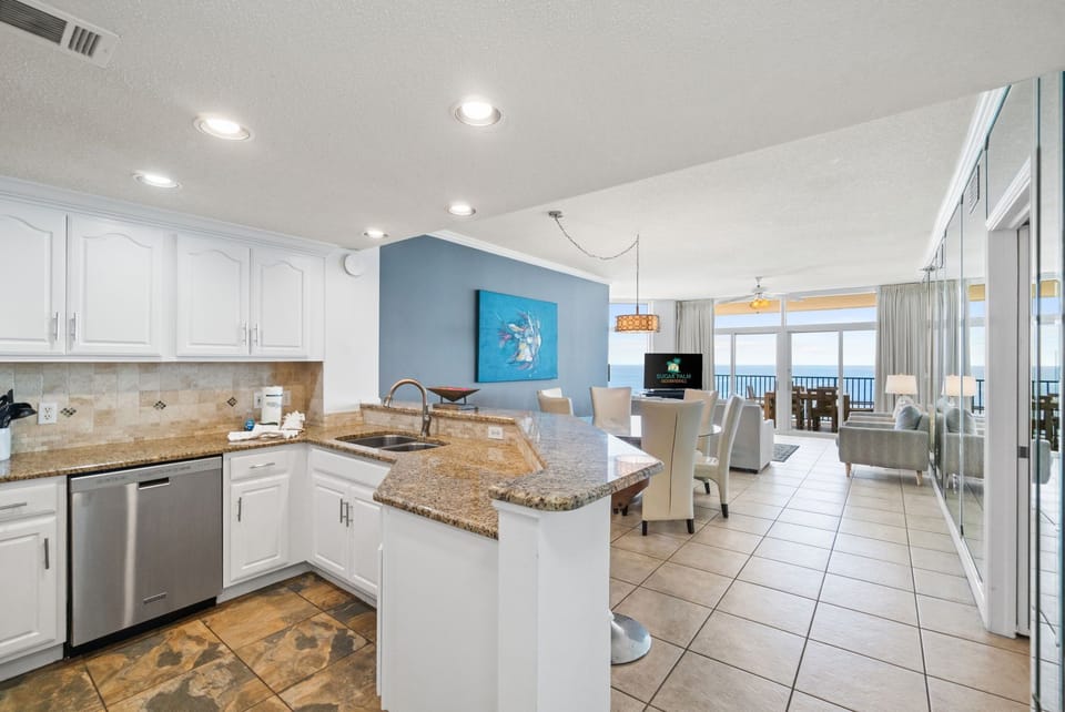 Modern kitchen and dining area with ocean views and bright, airy decor.
