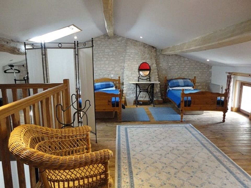 Twin beds with a 3rd single bed behind the screen 