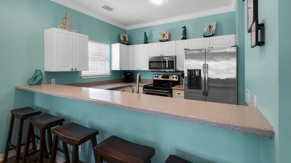 Modern stainless appliances in this open and very functional kitchen