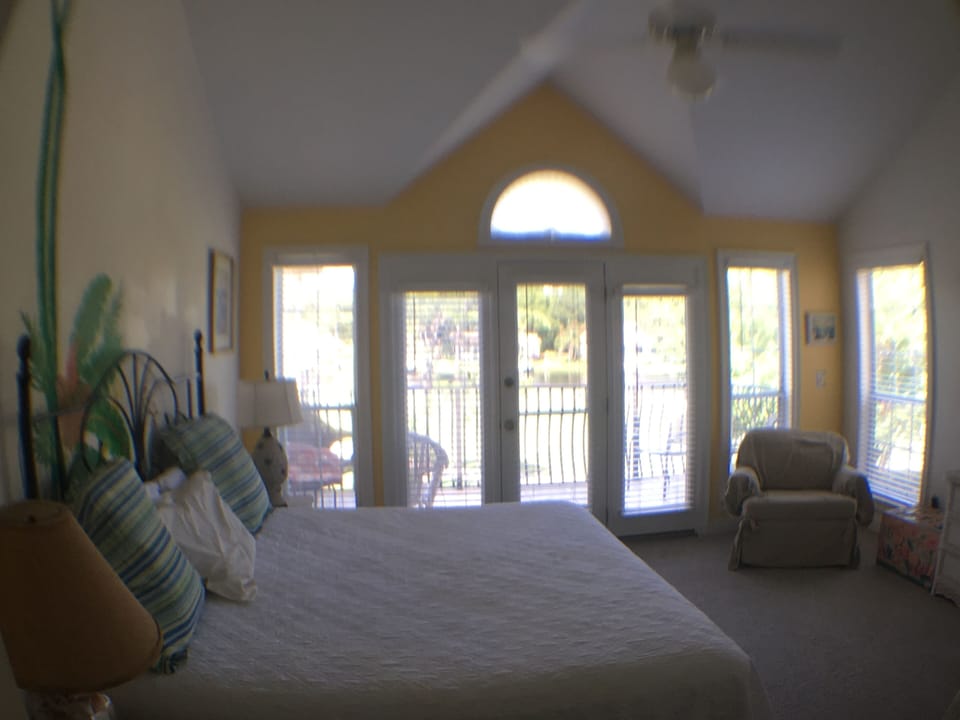 Upstairs Master with King bed with deck overlooking golf course, lake and bay