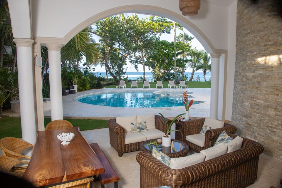 Terrace with outdoor kitchen and bar overlooking the pool