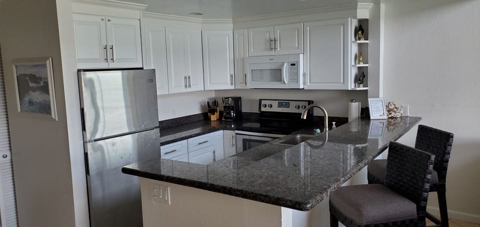 Updated kitchen with new cabinet doors, granite, stainless steel appliances