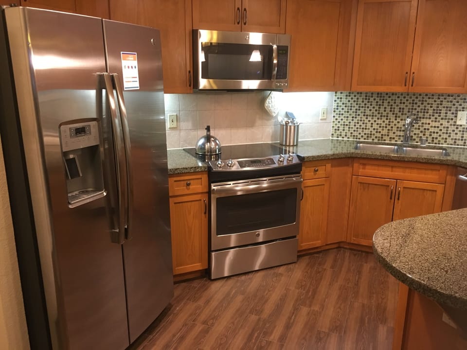Kitchen area with refrigerator