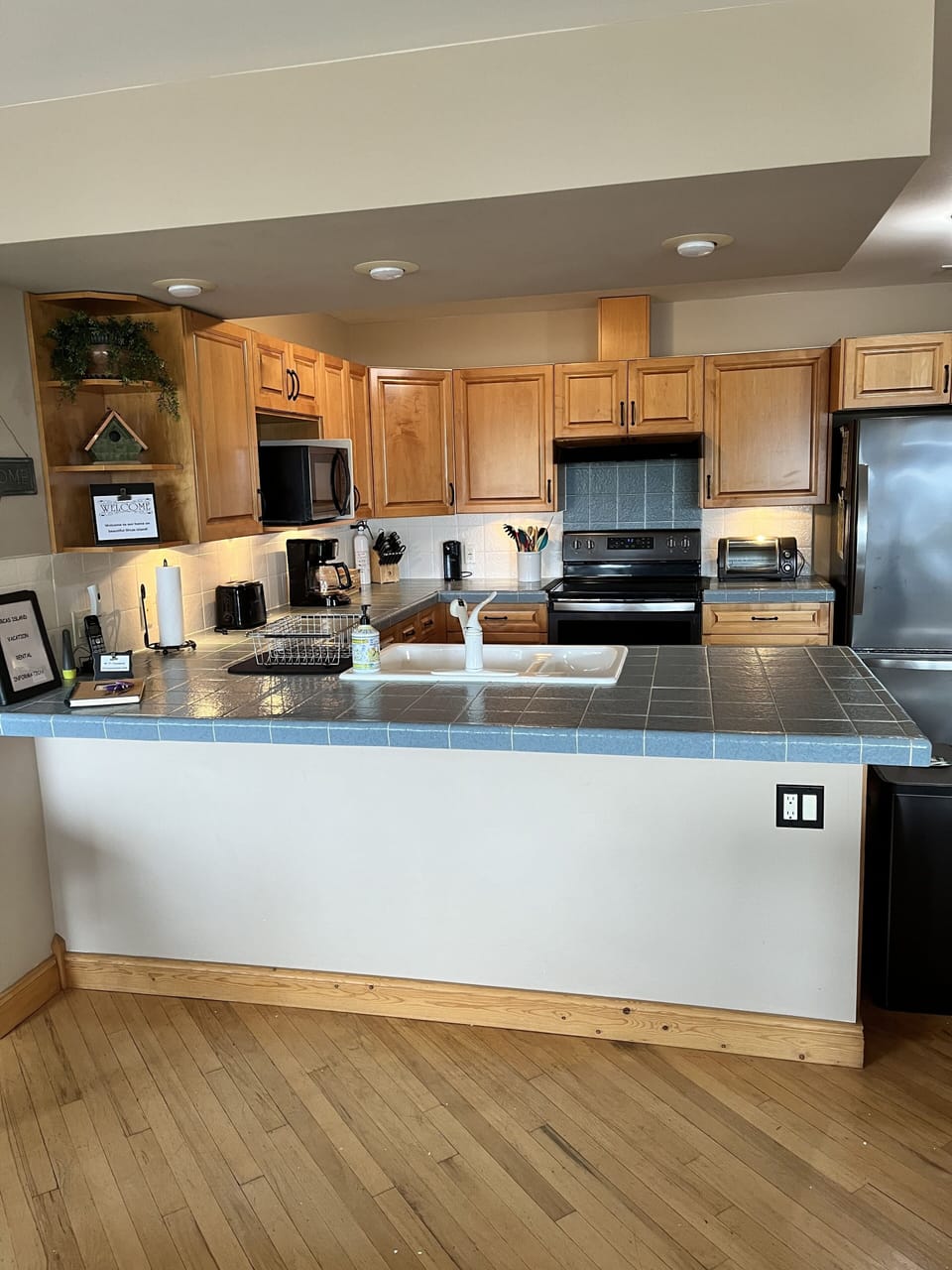 Spacious fully stocked kitchen with new black stainless-steel appliances