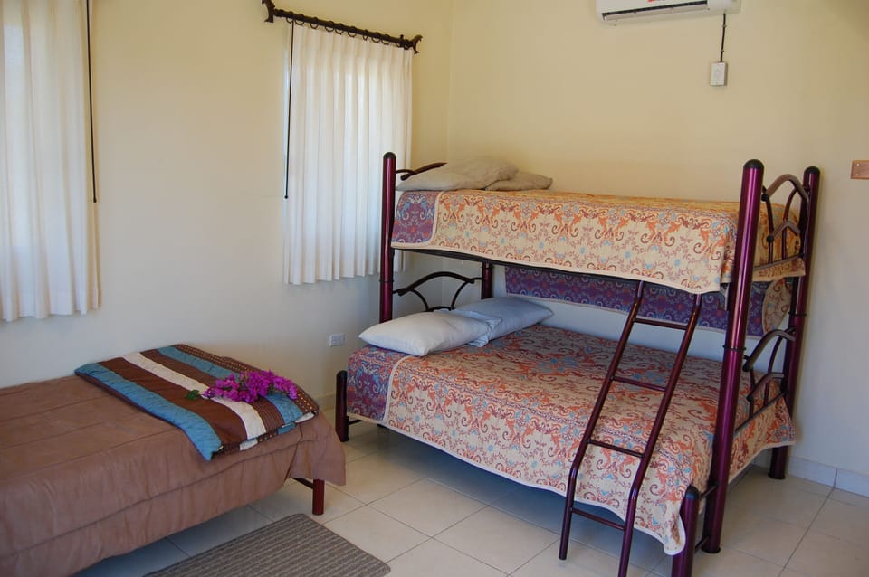 Guest Villa guest bedroom has 2 twin beds and a double.