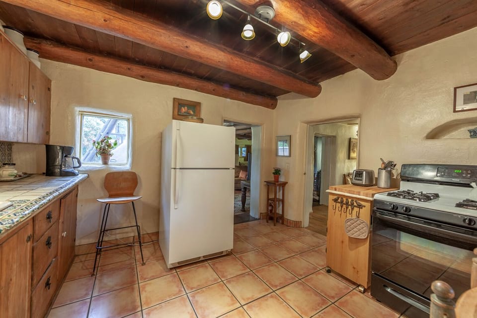 A sweet, traditional kitchen with everything you need to prepare and serve meals