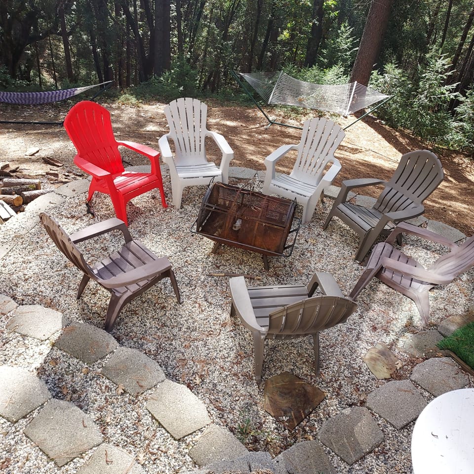 Firepit right next to spa, outdoor shower and hammocks