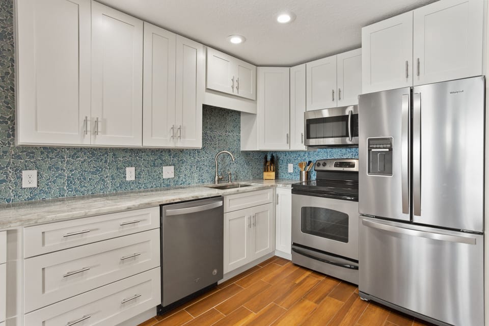 All new cabinets, beautiful custom backsplash and lots of granite counters.