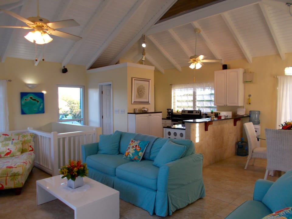 Kitchen overlooking great room with beautiful vaulted wood beam cielings