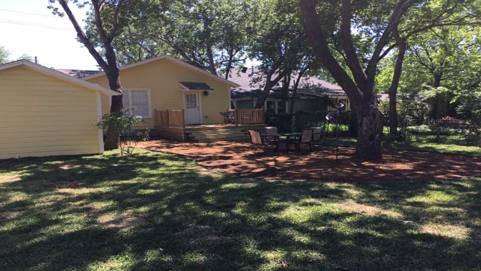 Shaded backyard with deck perfect for entertaining 