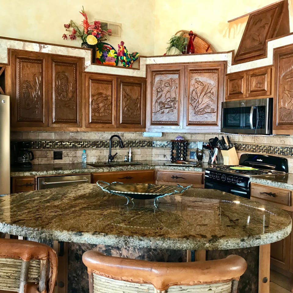 Hand carved cabinets, gas stove, granite counter tops