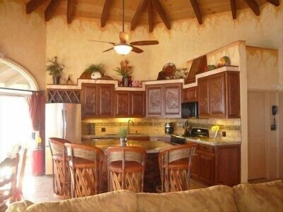 Kitchen features, hand carved cabinets, copper sink, ice maker, granite counter 