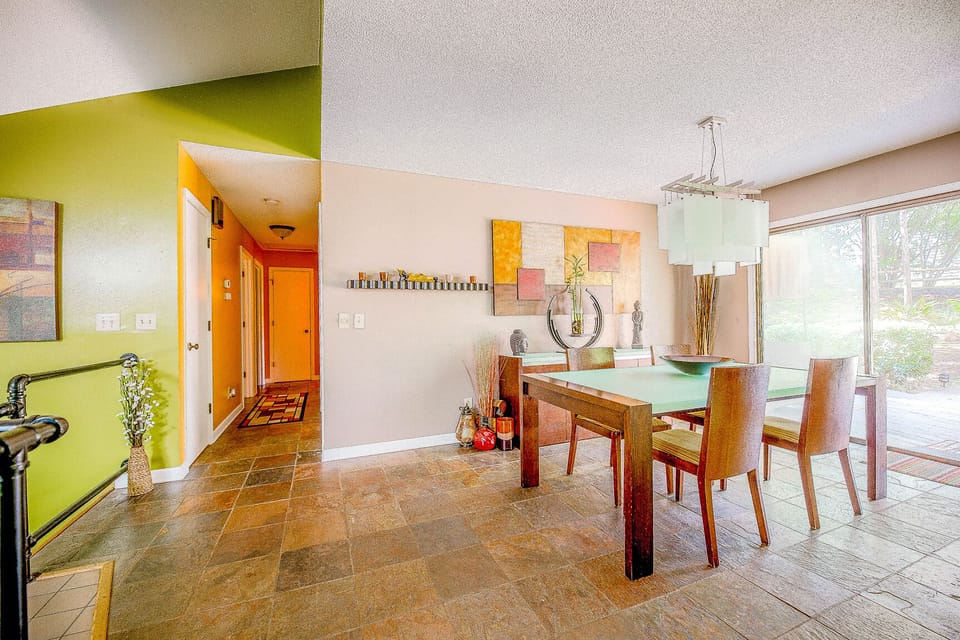 The hallway leading to the three bedrooms and the dining room table with the view to the backyard...