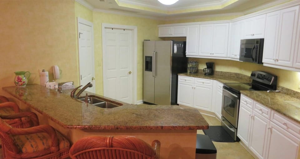 Fully equipped kitchen has granite counter tops, bar chairs, & gourmet utensils!