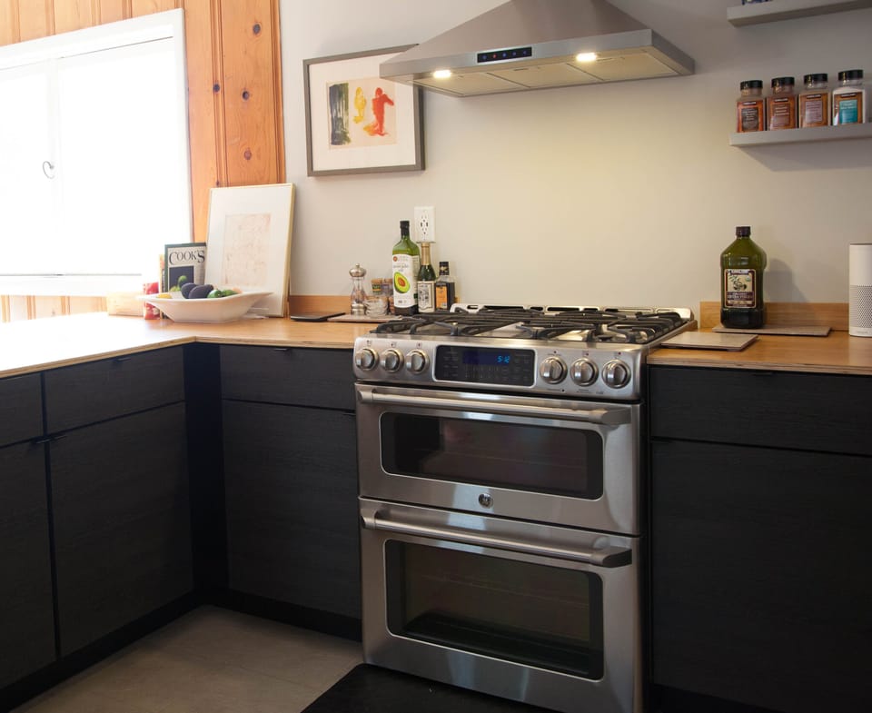 Kitchen with gas double-oven range and dishwasher.