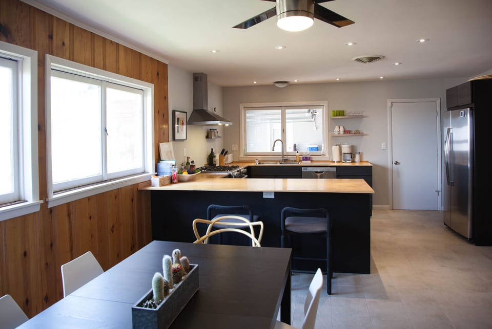 Kitchen with gas double-oven range and dishwasher.