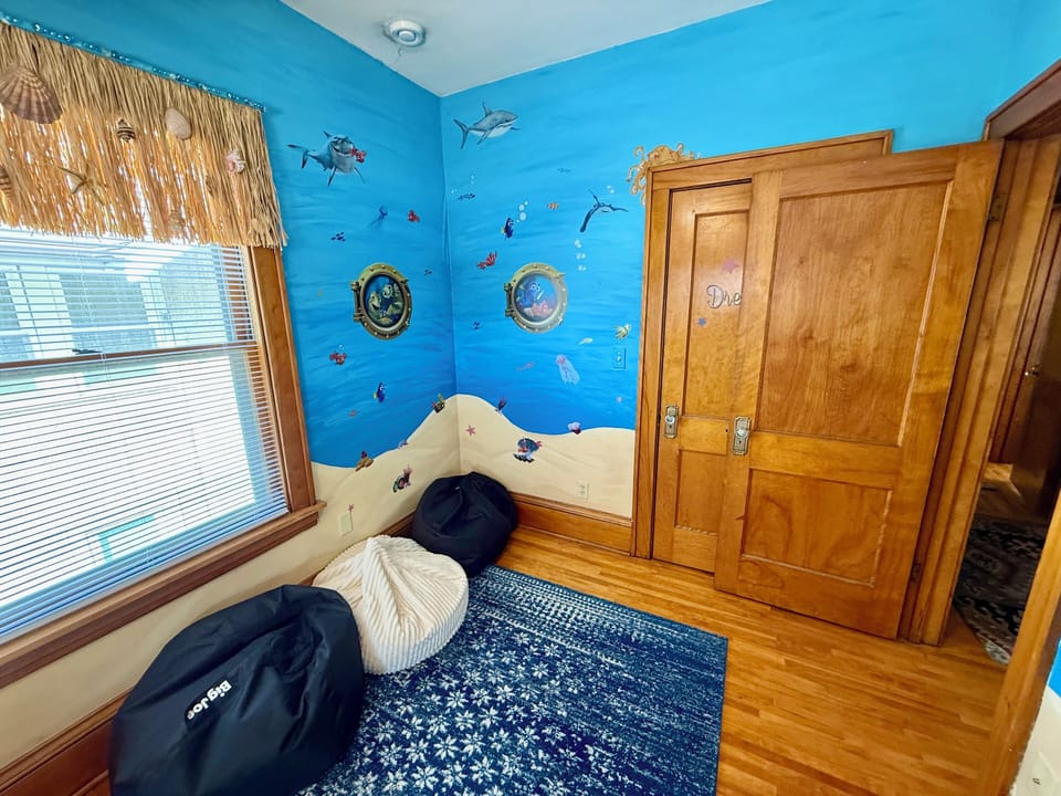 Dive into your underwater adventure bedroom with vibrant ocean murals, porthole windows, and cozy built-in seating that sparks imagination.