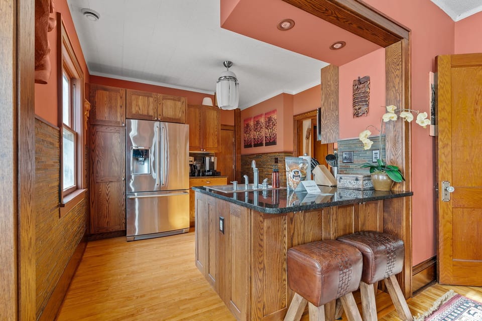 Step into your fully equipped kitchen featuring rich wood cabinetry, granite countertops, and modern stainless steel appliances ready for culinary adventures.