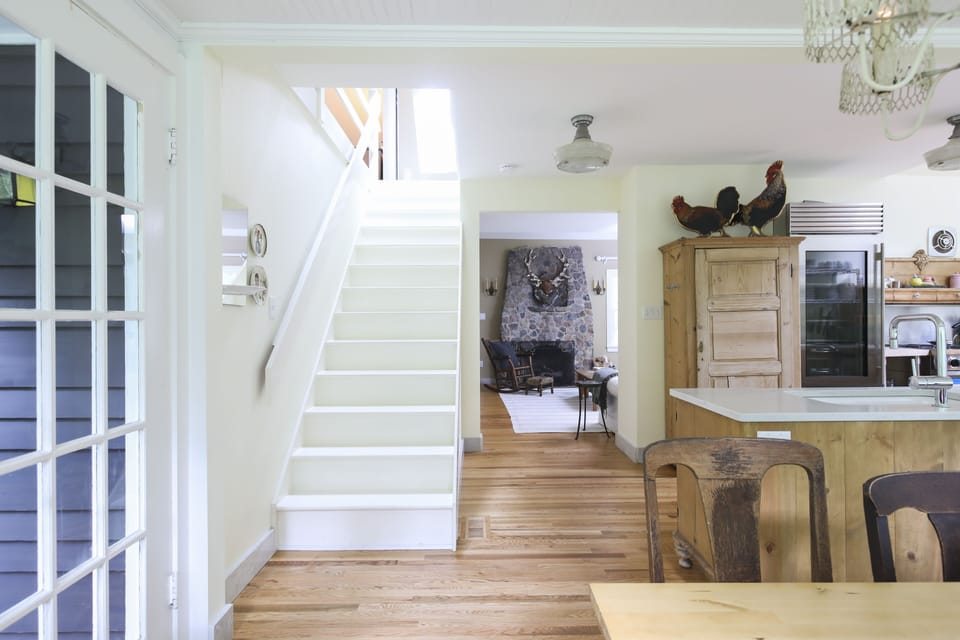 kitchen area into living room, plus stairs to lofted master bedroom