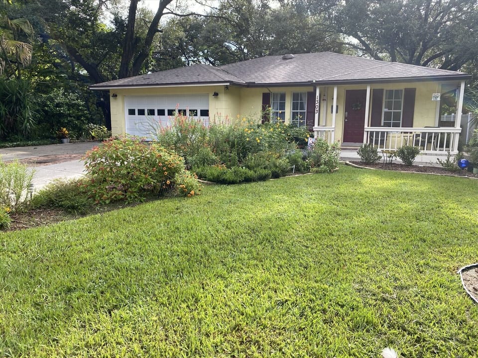 Front of the house with the butterfly gardens.