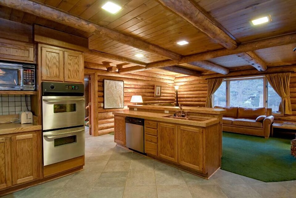 Kitchen complete with double oven, copper sink, dishwasher, and 6-burner stove.