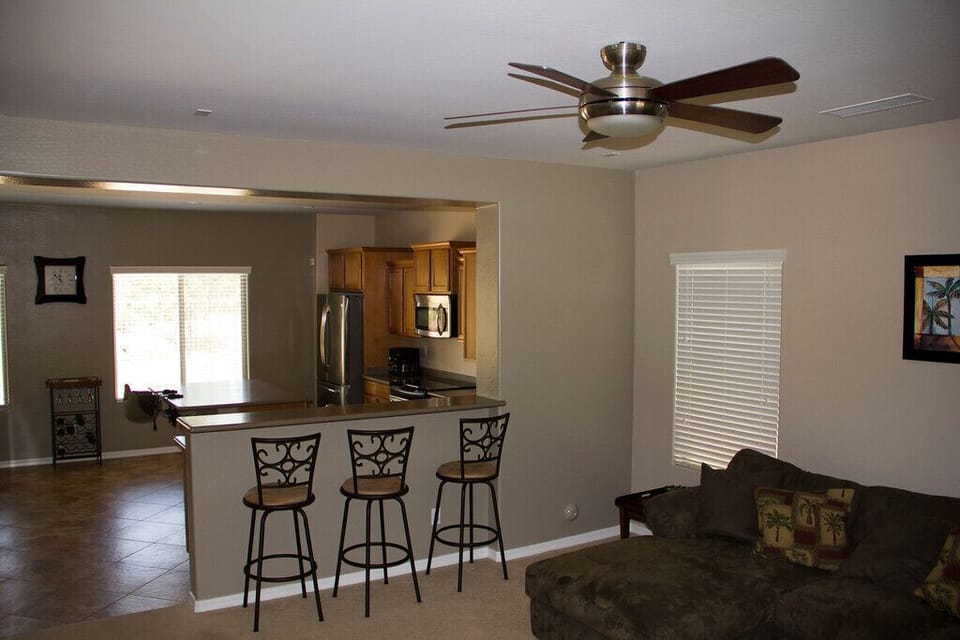 Living room looking into kitchen with bar stools