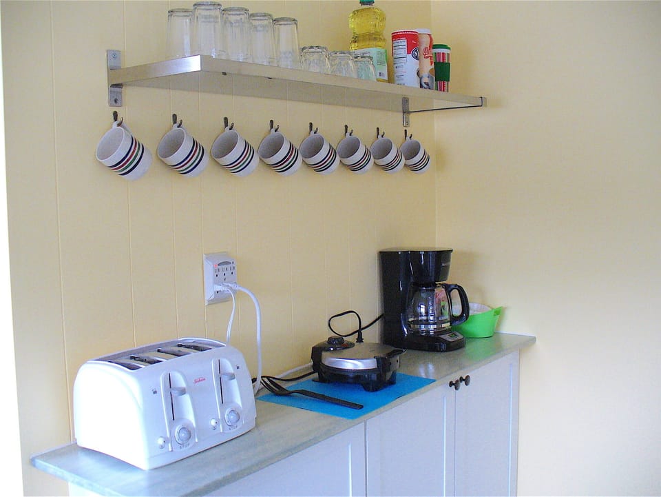 Coffee nook supplied with Coffee, sugar, creamer.  Waffle maker, mix, and syrup.