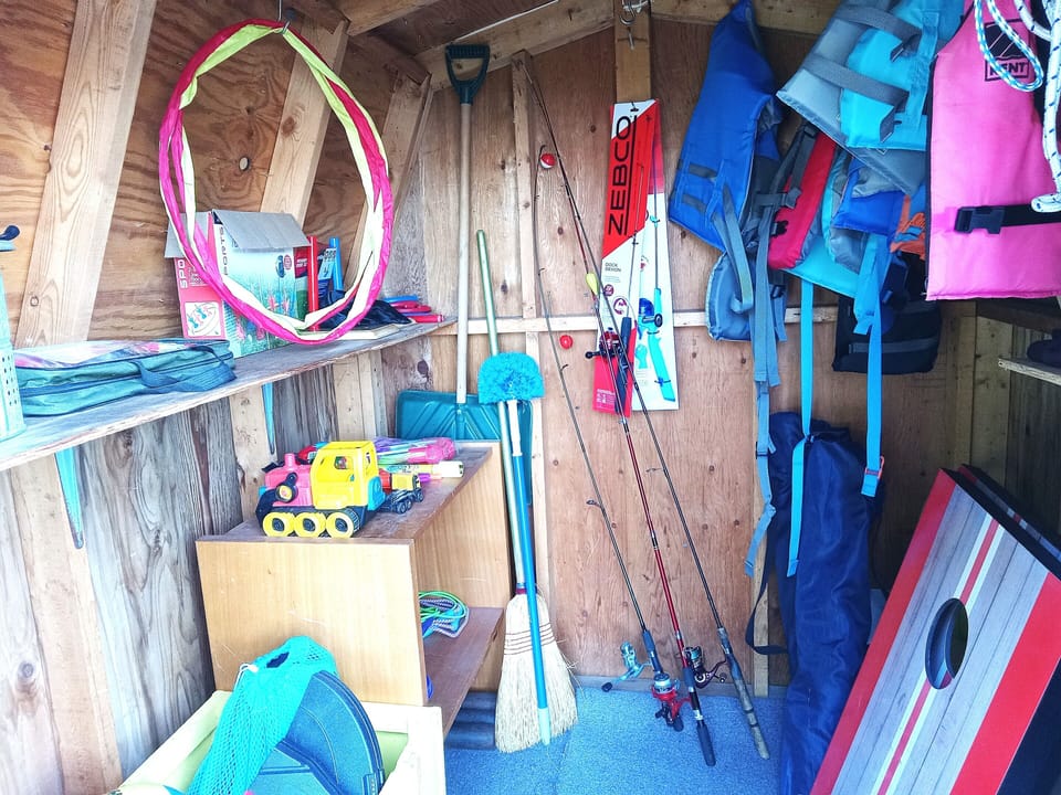 Lots of outdoor games, fishing equipment and charcoal in the storage shed.